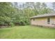 Spacious backyard with lush green lawn and mature trees offers a private outdoor retreat at 3605 Laurel Creek Way, Durham, NC 27712