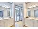 A spacious bathroom with double vanities, white cabinets, and entry to an outdoor patio at 3605 Laurel Creek Way, Durham, NC 27712