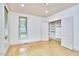 A bedroom with hardwood floors, closet with double doors, and natural light from one window at 3605 Laurel Creek Way, Durham, NC 27712