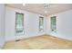 An empty bedroom with three windows and hardwood floors and a ceiling fan at 3605 Laurel Creek Way, Durham, NC 27712
