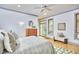 Bedroom with a ceiling fan, wood floors, and backyard access at 3605 Laurel Creek Way, Durham, NC 27712