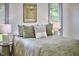 A cozy bedroom featuring a queen size bed and accent lamps and natural light at 3605 Laurel Creek Way, Durham, NC 27712