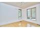 A bedroom with hardwood floors and two windows that allow lots of natural light at 3605 Laurel Creek Way, Durham, NC 27712