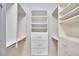 A walk-in closet with built-in shelving and drawers with chrome drawer pulls at 3605 Laurel Creek Way, Durham, NC 27712