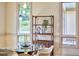 Intimate view of a dining room featuring a modern glass table, chairs, and stylish decor for cozy gatherings at 3605 Laurel Creek Way, Durham, NC 27712