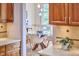 Dining area featuring a glass table, four chairs, and stylish decor as seen from the kitchen at 3605 Laurel Creek Way, Durham, NC 27712