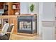 Close-up of a modern fireplace with a decorative surround and built-in wooden shelving at 3605 Laurel Creek Way, Durham, NC 27712