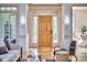 Bright foyer with wood door, sidelights, transom window, hardwood floors, and neutral color palette at 3605 Laurel Creek Way, Durham, NC 27712