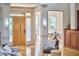 Bright entryway showcasing hardwood floors, a wooden door, high ceilings, and seamless access to other living spaces at 3605 Laurel Creek Way, Durham, NC 27712