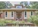 Charming one-story home featuring brick detailing, a manicured garden, and an inviting wooden front door at 3605 Laurel Creek Way, Durham, NC 27712