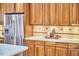 Kitchen with stainless steel refrigerator, wood cabinets and white countertops at 3605 Laurel Creek Way, Durham, NC 27712