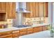 Kitchen with stainless steel range hood, cooktop, wood cabinets and white countertops at 3605 Laurel Creek Way, Durham, NC 27712