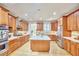 Spacious kitchen featuring wood cabinets, stainless steel appliances, and a center island, perfect for culinary enthusiasts at 3605 Laurel Creek Way, Durham, NC 27712