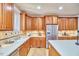 Spacious kitchen featuring wood cabinets, stainless steel refrigerator, and white countertops at 3605 Laurel Creek Way, Durham, NC 27712