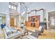 Open concept living room featuring high ceilings, hardwood floors, a fireplace, and built-in shelving at 3605 Laurel Creek Way, Durham, NC 27712