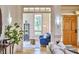 Inviting living room featuring a bright interior, a blue sofa, an eye-catching front door, and stylish decor at 3605 Laurel Creek Way, Durham, NC 27712