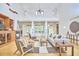 Spacious living room featuring high ceilings, a ceiling fan, large windows, and neutral decor at 3605 Laurel Creek Way, Durham, NC 27712