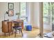 Bright home office space featuring a wooden desk, a comfortable chair, and natural light from multiple windows at 3605 Laurel Creek Way, Durham, NC 27712