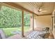 Covered porch provides a serene outdoor living space with a ceiling fan and views at 3605 Laurel Creek Way, Durham, NC 27712