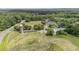 Aerial view showcasing a large home and its surrounding fields and trees at 384 Lyndfield Cl W, Pittsboro, NC 27312