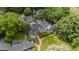 Aerial view of a luxury home with beautiful landscaping, gardens, and mature trees at 384 Lyndfield Cl W, Pittsboro, NC 27312