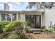 Charming backyard patio with sliding glass doors, deck, and lush landscaping at 384 Lyndfield Cl W, Pittsboro, NC 27312