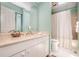 Bright bathroom featuring a light countertop vanity, commode, shower and tub at 384 Lyndfield Cl W, Pittsboro, NC 27312