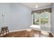 Cozy breakfast nook with large window and a charming table and chairs set at 384 Lyndfield Cl W, Pittsboro, NC 27312