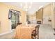 Open dining area connected to the living room, featuring a chandelier and ample natural light for delightful meals at 384 Lyndfield Cl W, Pittsboro, NC 27312