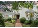 Charming two-story home featuring a brick walkway and well-manicured landscaping at 384 Lyndfield Cl W, Pittsboro, NC 27312