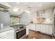 Well-lit kitchen with stainless appliances, granite counters, and stylish backsplash at 384 Lyndfield Cl W, Pittsboro, NC 27312