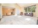 Open concept living area featuring large windows and seamless flow into dining area, perfect for entertaining at 384 Lyndfield Cl W, Pittsboro, NC 27312