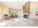 Spacious living room featuring a fireplace, built-in shelving, and a large window, creating a bright and airy space at 384 Lyndfield Cl W, Pittsboro, NC 27312