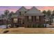 Two-story home with brick and siding exterior, manicured lawn, and inviting entrance at dusk at 40 Ironwood Blvd, Youngsville, NC 27596