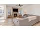 Bright living room with a stone fireplace, large sectional sofa, and hardwood flooring at 40 Ironwood Blvd, Youngsville, NC 27596