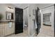 Bathroom with vanity, toilet, and hallway access, featuring tile floors and neutral paint at 4001 Falls River Ave, Raleigh, NC 27614