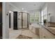 Bathroom featuring a separate glass shower, soaking tub, and vanity with granite counters at 4001 Falls River Ave, Raleigh, NC 27614