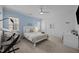 Bright bedroom with bed, desk, and soothing blue accent wall at 4001 Falls River Ave, Raleigh, NC 27614