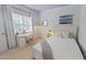 Cozy bedroom with a single bed, desk, and plenty of natural light at 4001 Falls River Ave, Raleigh, NC 27614