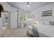 Well-lit bedroom features carpet flooring and access to the room's entryway at 4001 Falls River Ave, Raleigh, NC 27614