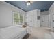 An expansive bedroom with neutral walls, window views, and carpet floors at 4001 Falls River Ave, Raleigh, NC 27614