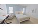 Comfortable bedroom with white furnishings and a large window at 4001 Falls River Ave, Raleigh, NC 27614