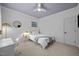 Cozy bedroom with white walls, round mirror, desk, and soft carpet flooring at 4001 Falls River Ave, Raleigh, NC 27614