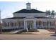 Community clubhouse featuring a classic architectural design and lush landscaping at 4001 Falls River Ave, Raleigh, NC 27614