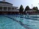 Community pool with marked lanes, lounge chairs, clubhouse, and well-maintained facilities at 4001 Falls River Ave, Raleigh, NC 27614