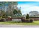 Community entrance sign with manicured landscaping and water feature at 4001 Falls River Ave, Raleigh, NC 27614