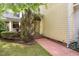 Side view of the home with brick pathway, black awning, and partially covered porch at 4001 Falls River Ave, Raleigh, NC 27614