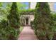 Pathway to the home's entrance, framed by lush greenery, leading to a welcoming front door at 4001 Falls River Ave, Raleigh, NC 27614
