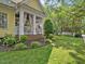 Charming exterior with yellow siding, inviting porch, and well-manicured lawn at 4001 Falls River Ave, Raleigh, NC 27614