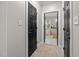 Hallway view of ensuite bathroom featuring neutral paint, black doors, and tile floor at 4001 Falls River Ave, Raleigh, NC 27614